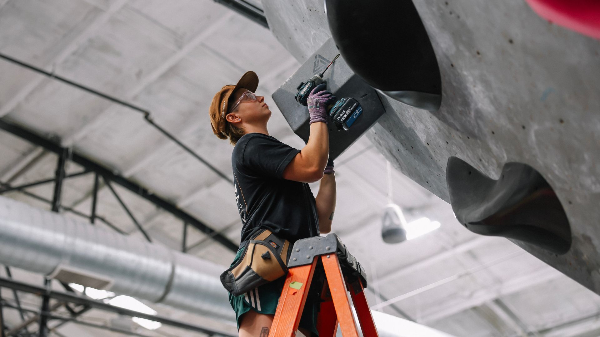 Jesse on a ladder setting a volume