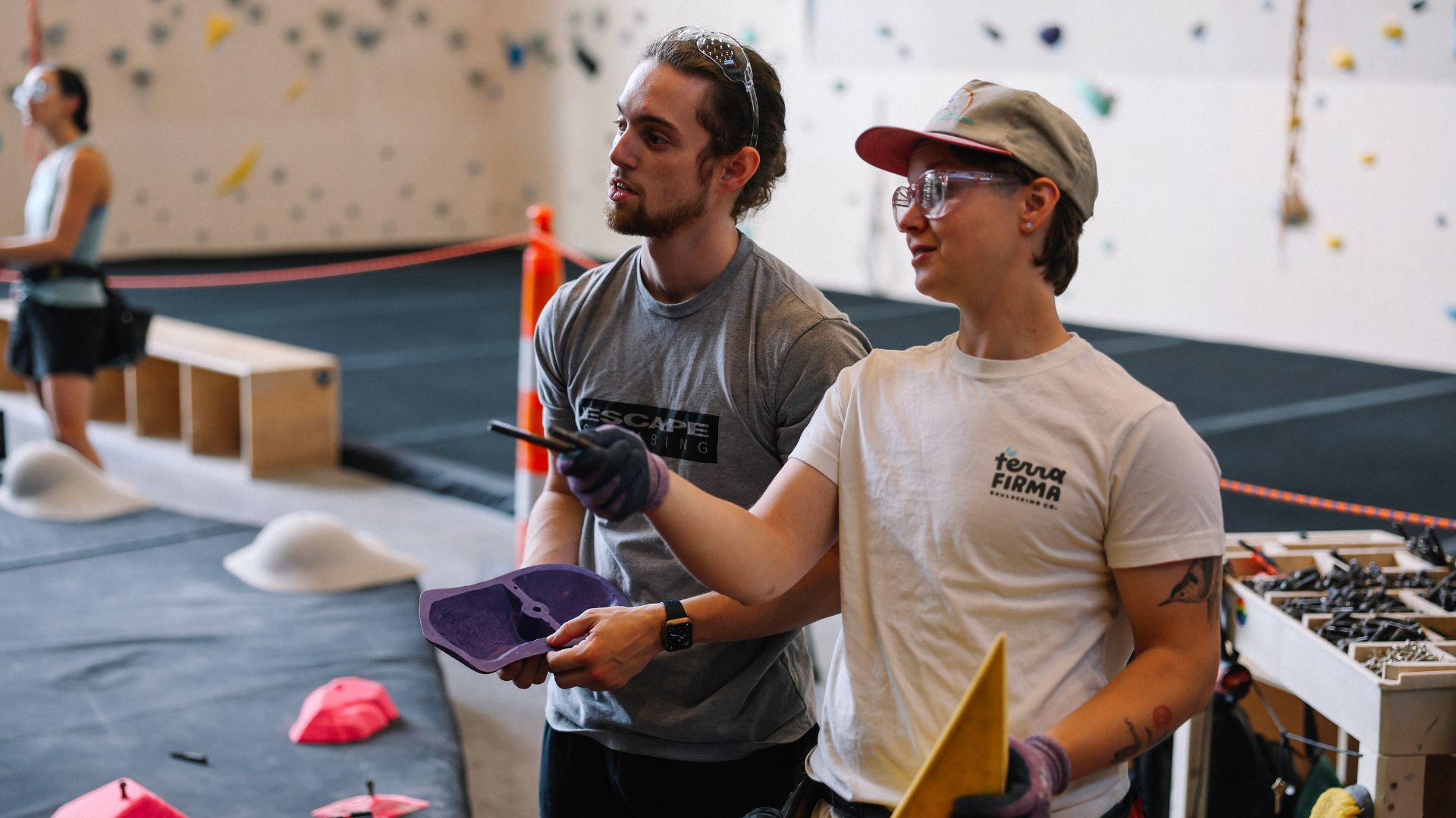 Jesse routesetting with another crew member