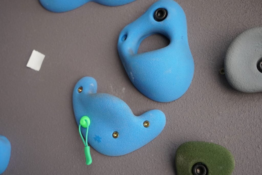 boulder route tags placed on jugs