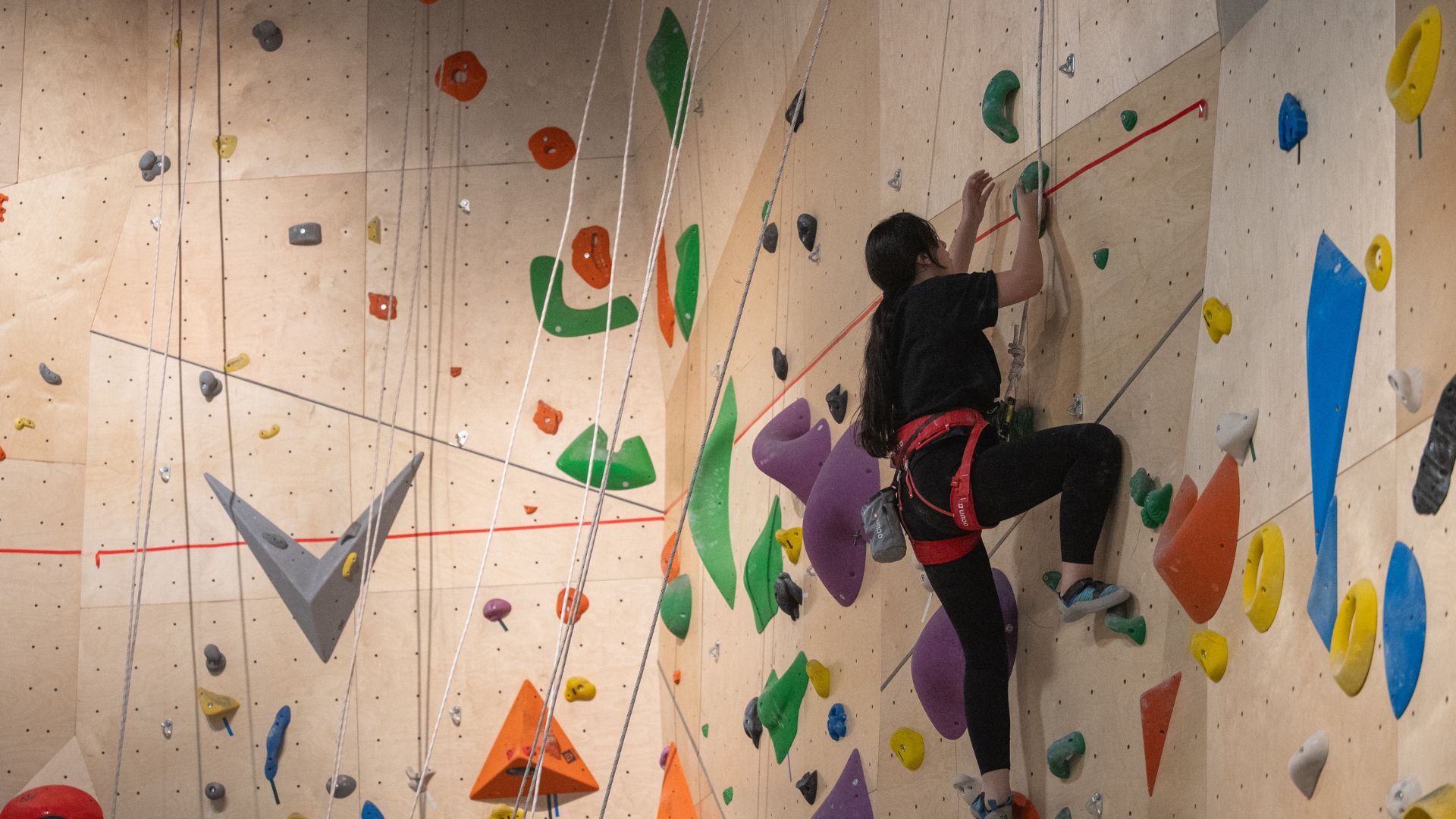 A climber ascends a roped wall at Ver Var