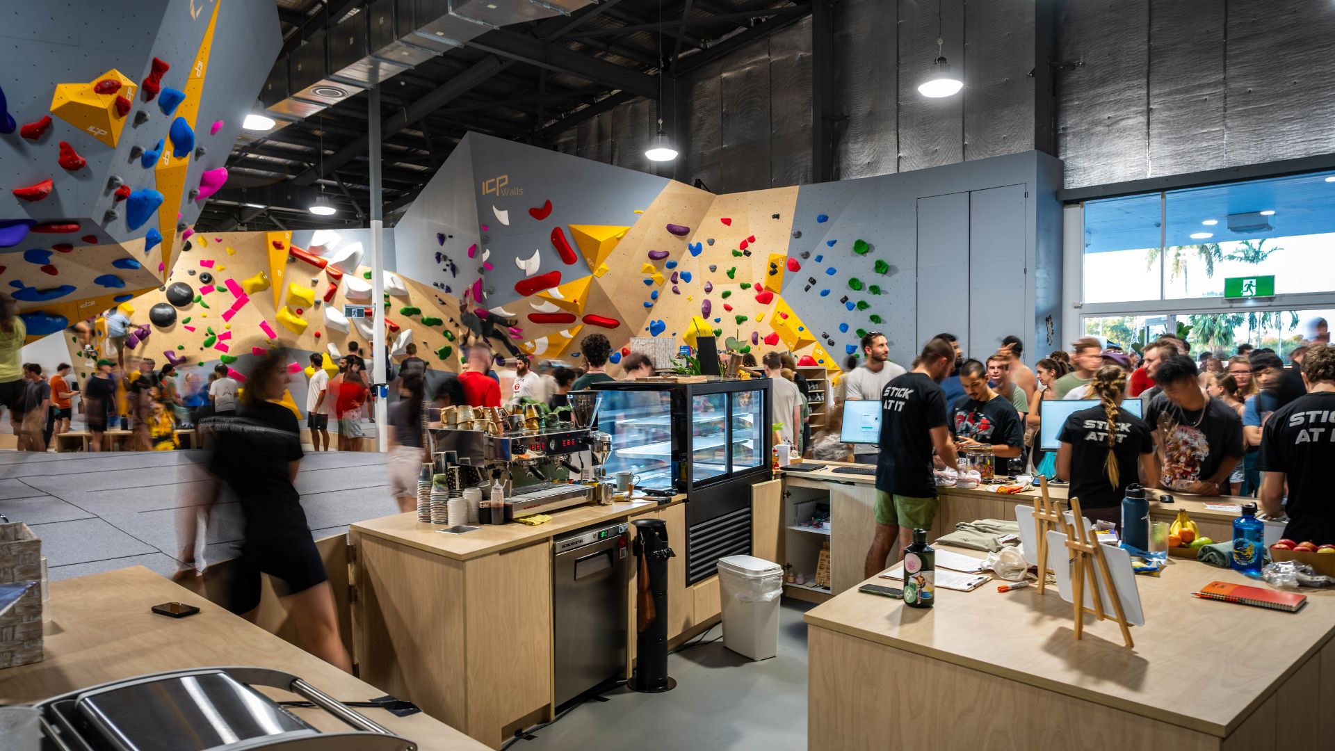 Climbers mingle around the café area inside the gym