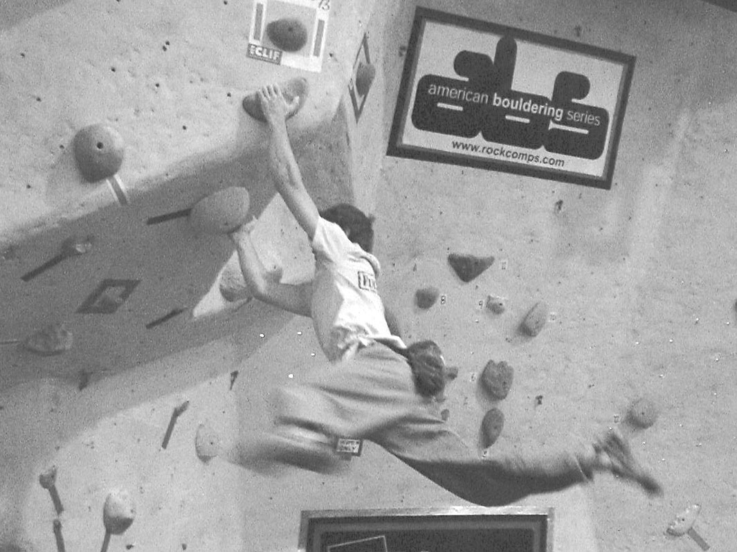 A competitor cuts feet at an ABS bouldering competition
