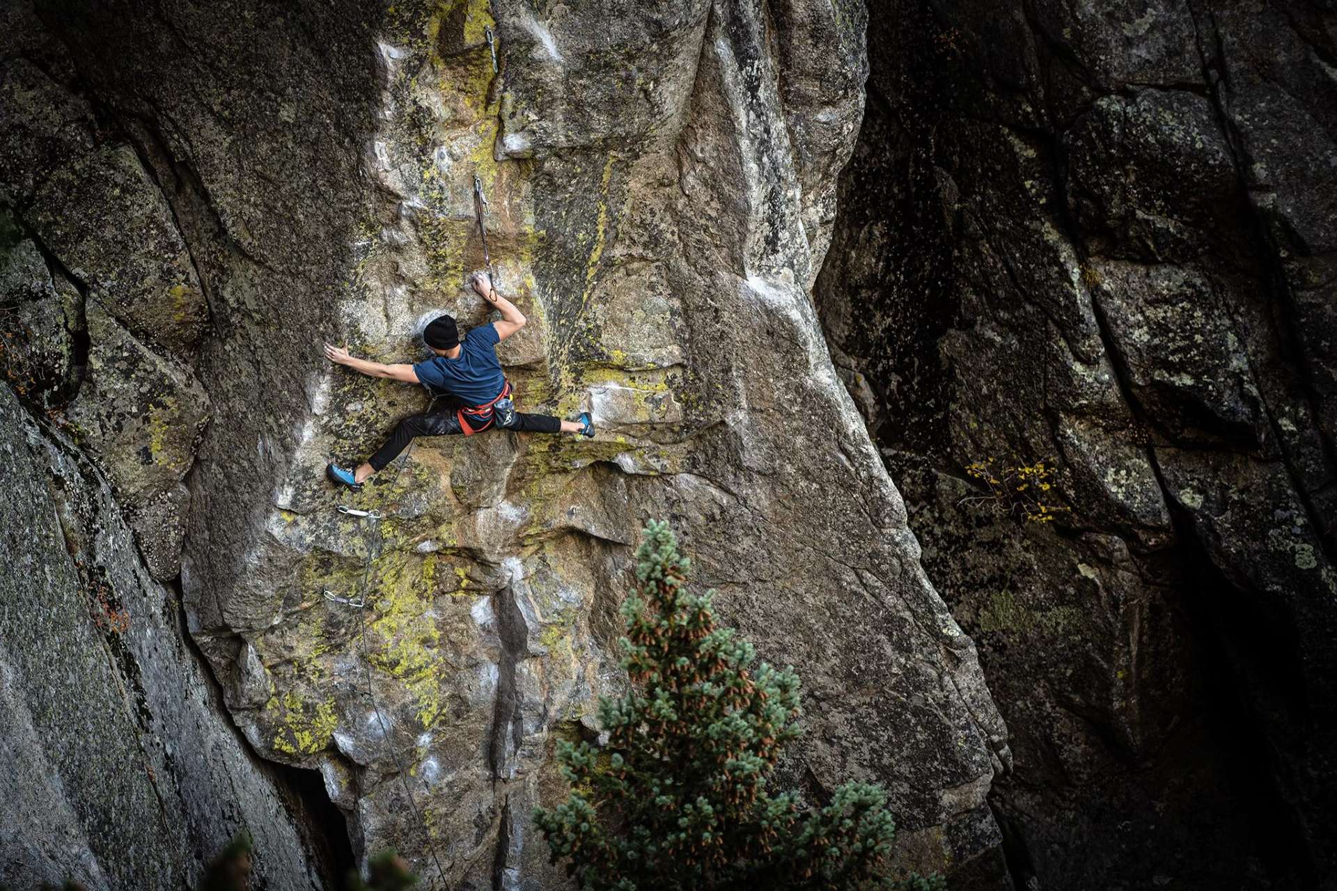 Dan climbing a rope route outdoors