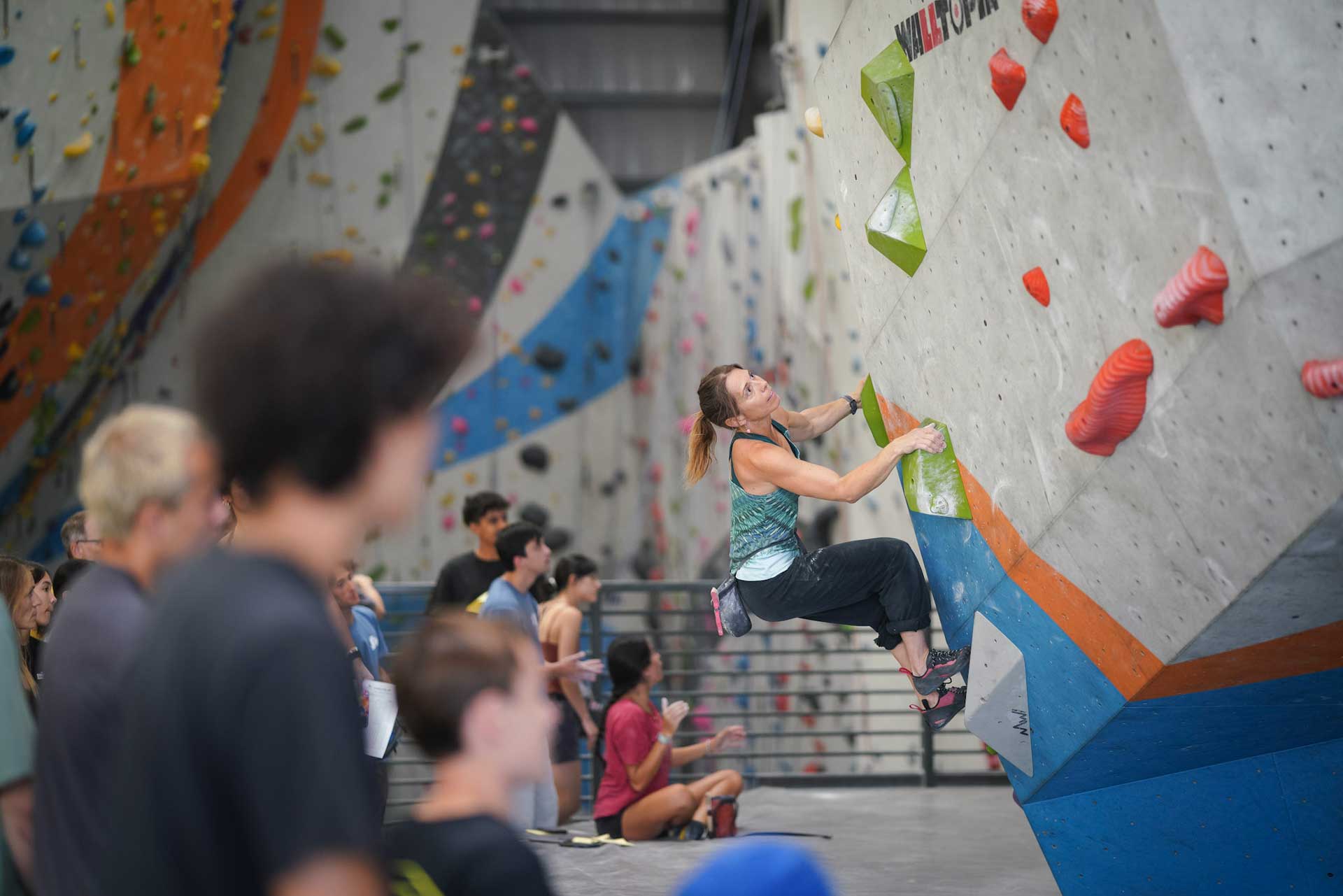 A climber ascends a boulder at Sender One's LAX gym