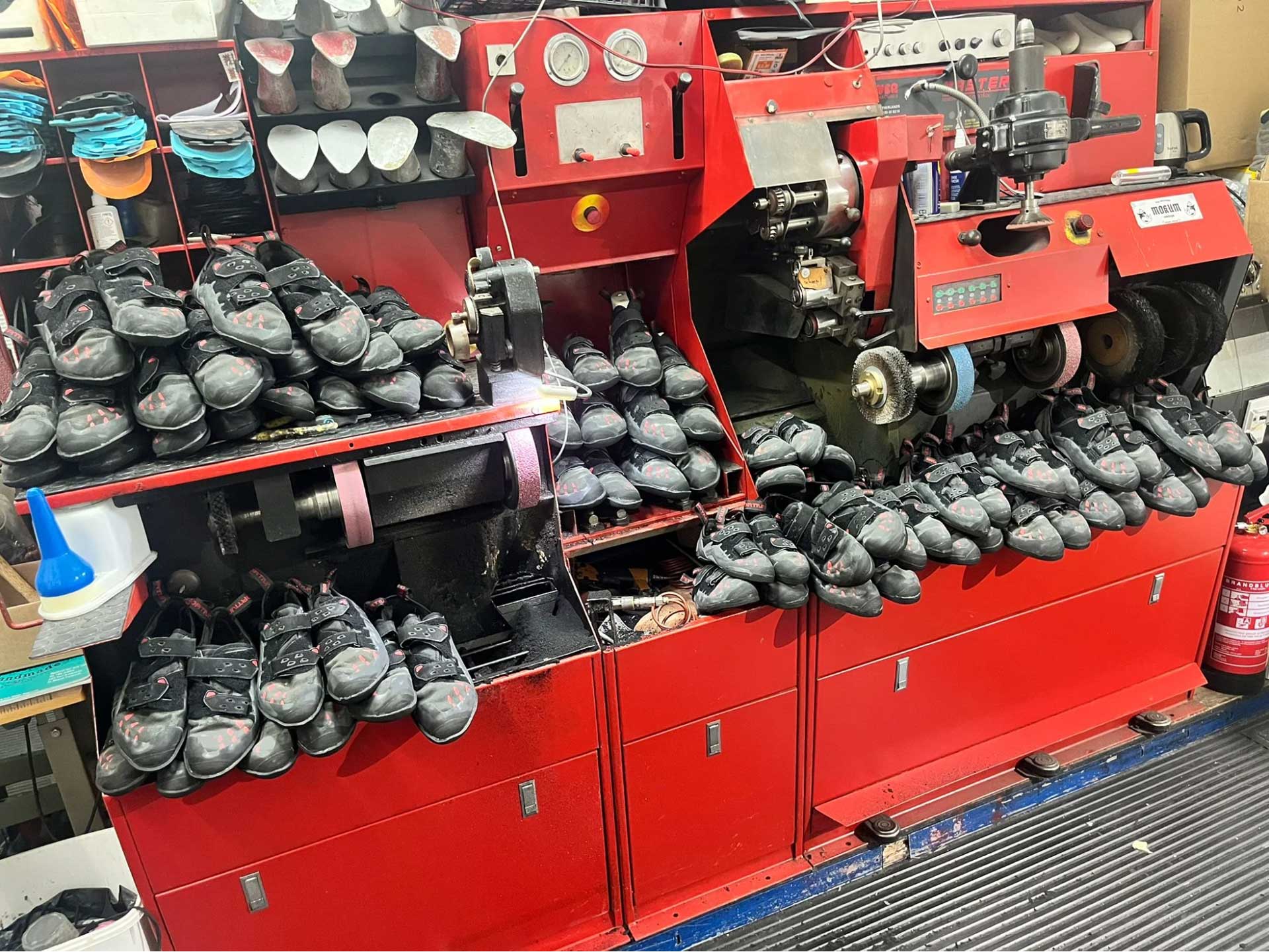 A specialized shoe repair machine used to grind and polish the rubber soles of climbing shoes