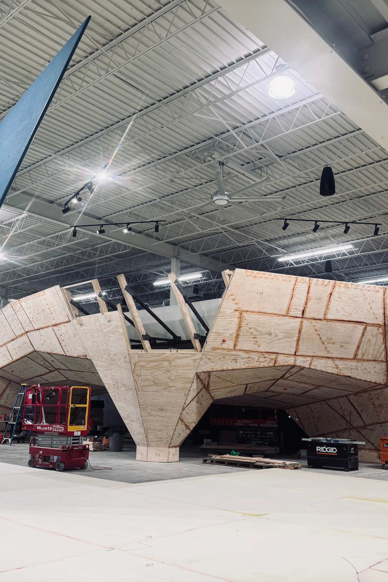 A sweeping bouldering wall mid-construction