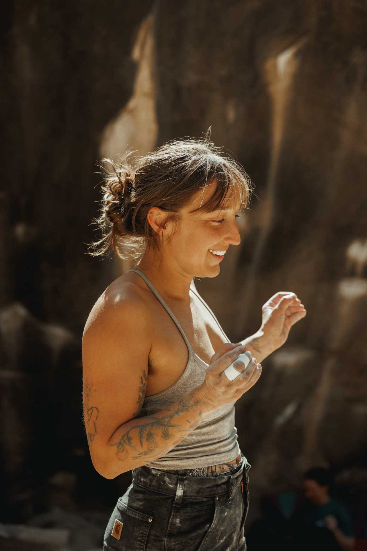 Sierra smiling during a bouldering session outside
