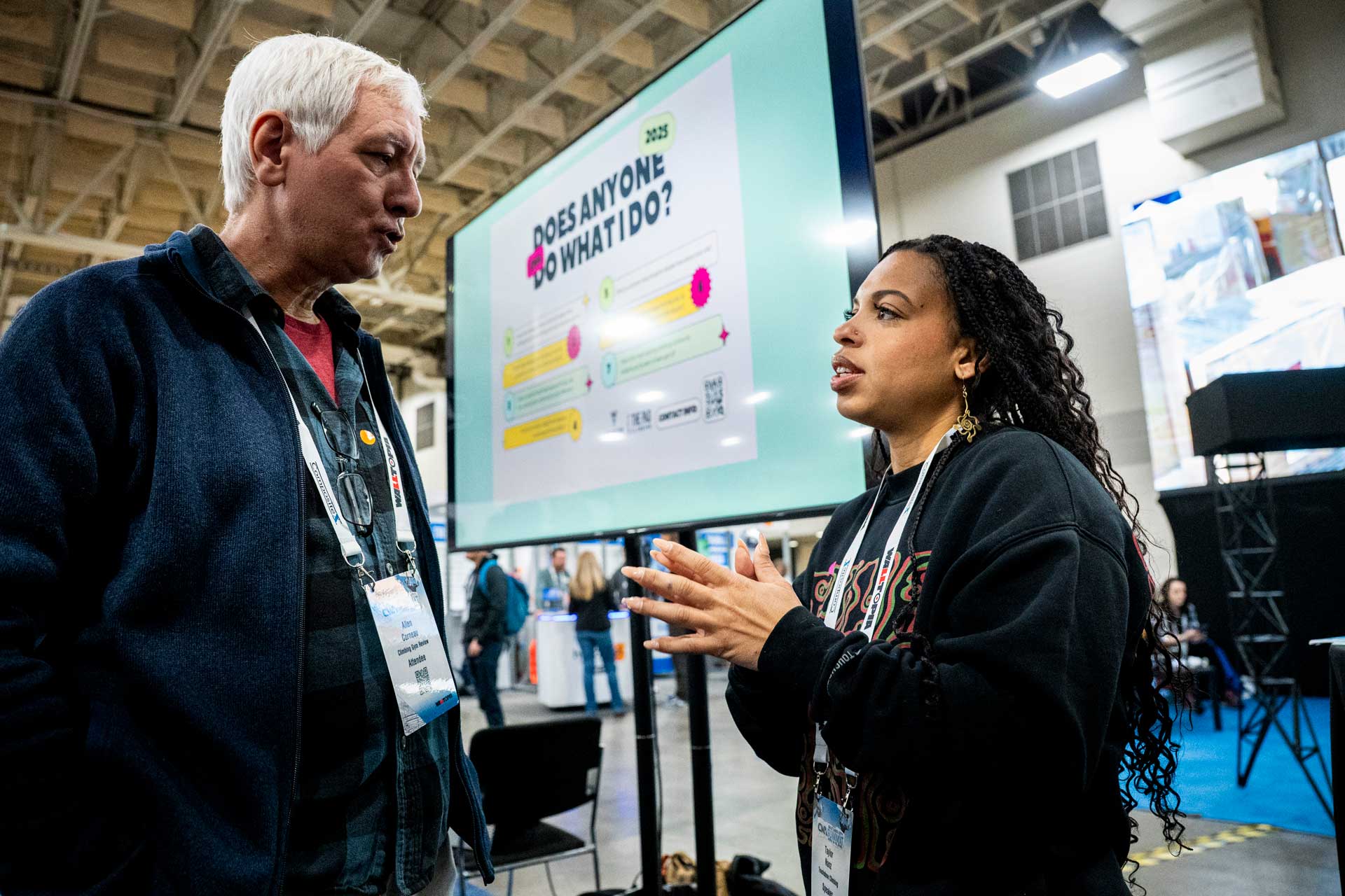 A speaker and attendee talking after a Community Hub