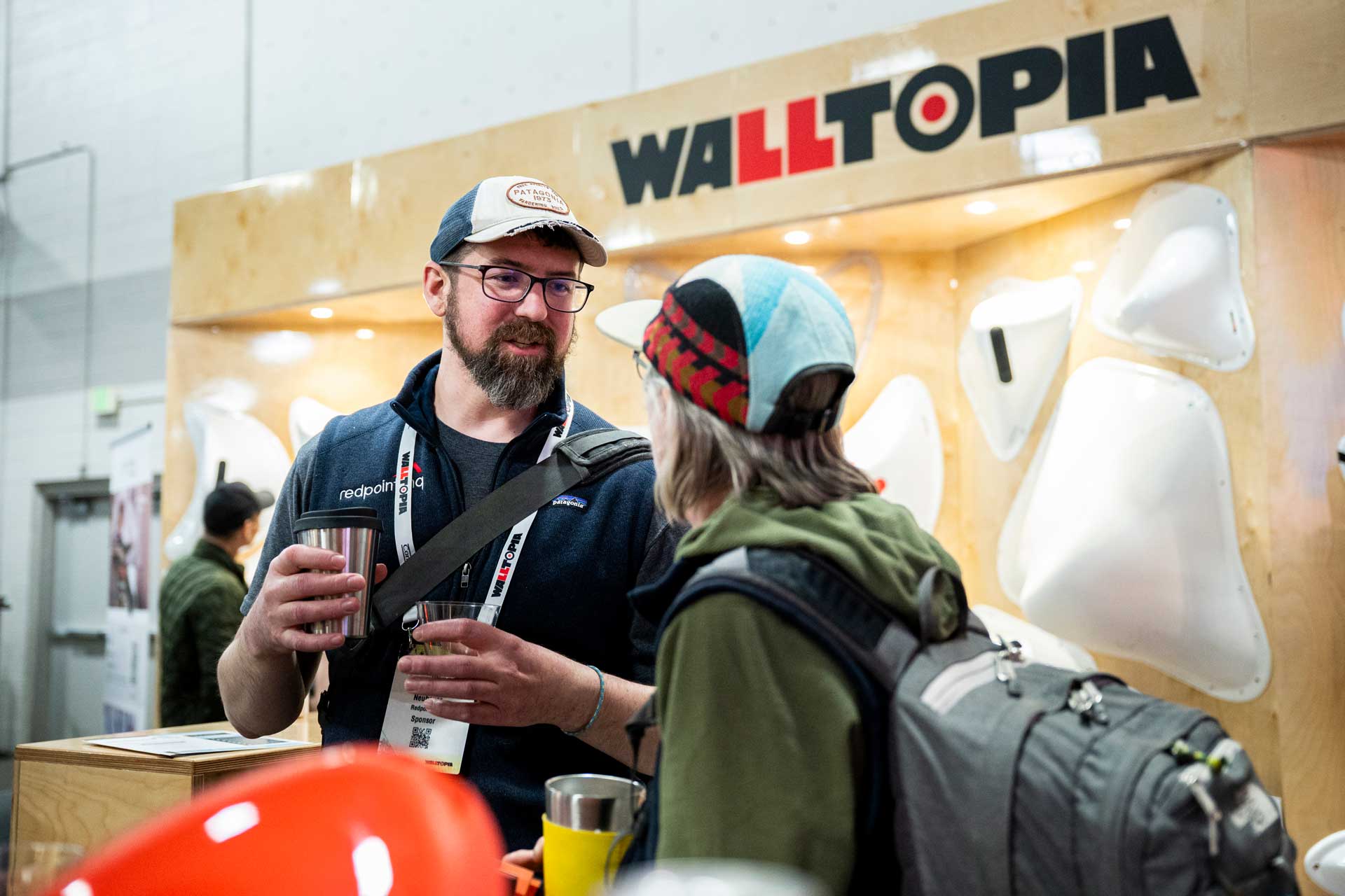 A vendor and attendee converse at the Walltopia booth last year