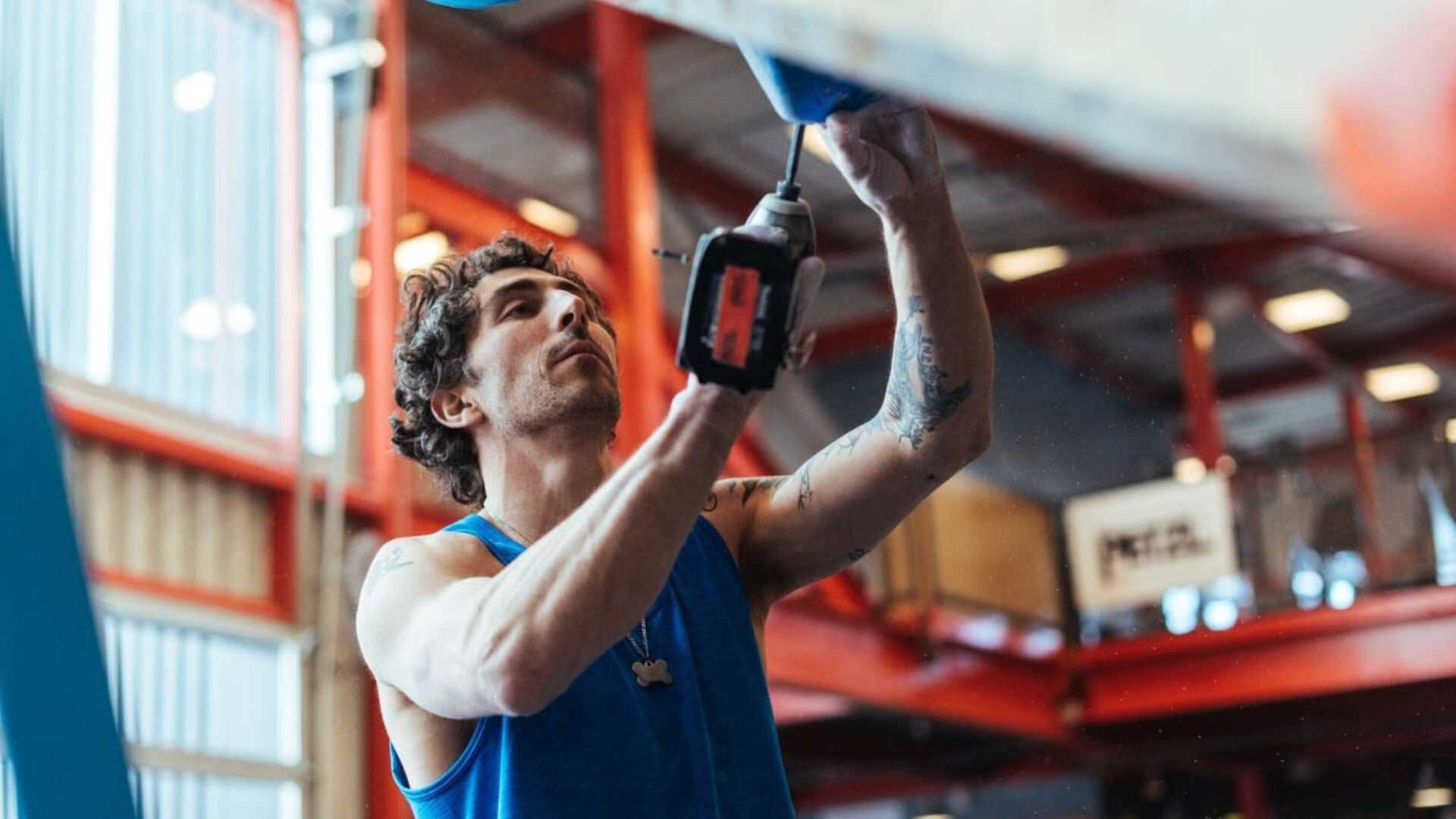 Mike Bockino drilling a hold onto the wall