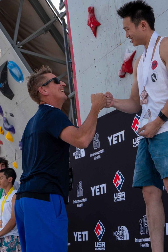 Marc Norman fist bumping a medalist