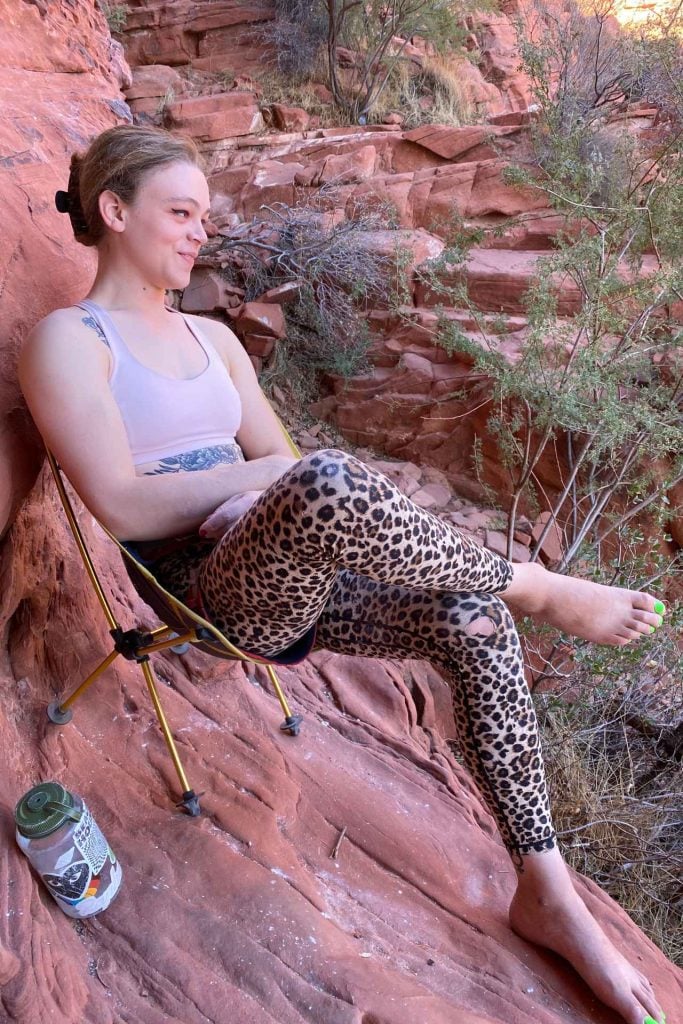 Zoey sitting on a chair at an outdoor crag