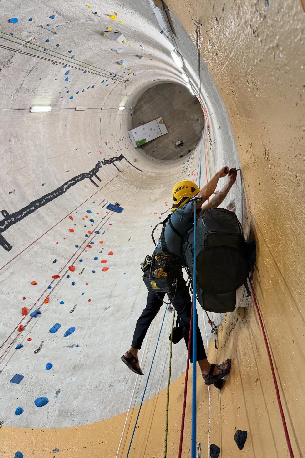 A routesetter works on a route inside the silos at High Plains Climbing