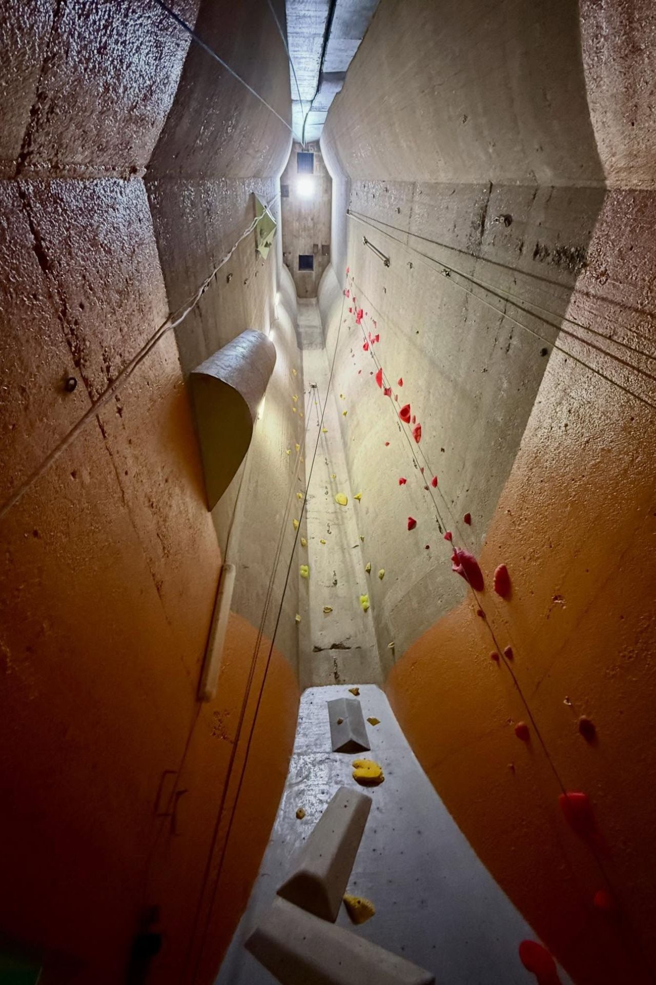 Looking up at a long climbing route inside the silos
