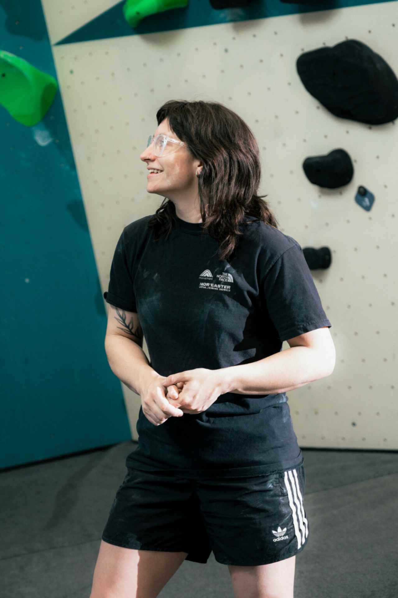 Altana smiling while routesetting at the gym