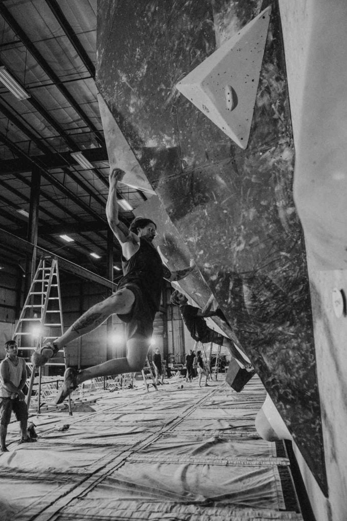Rylan foerunning a bouldering problem