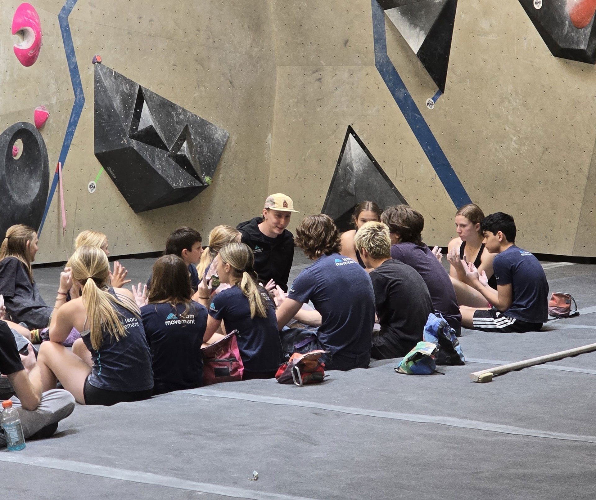 Meyer coaching a group of youth climbers in the gym