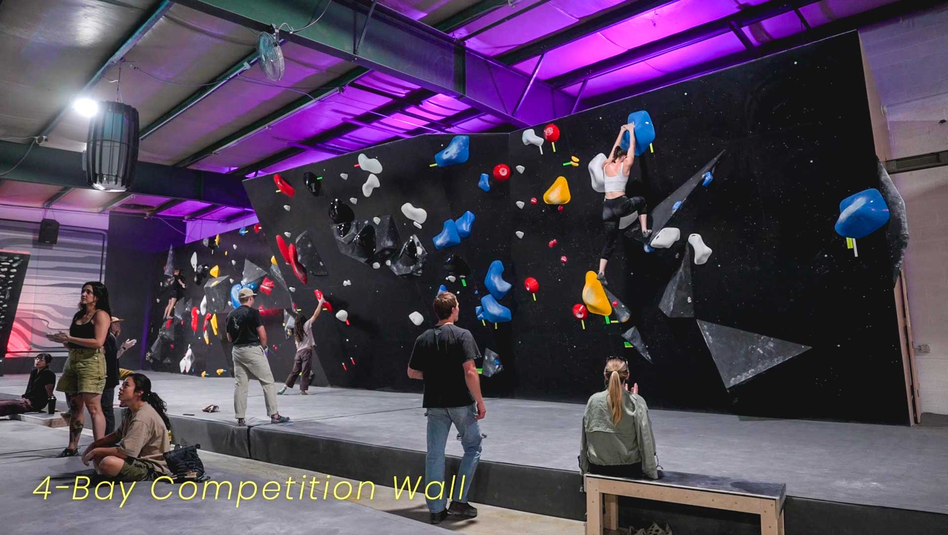 Athletes climbing on the 4-Bay Competition Wall at the TTC
