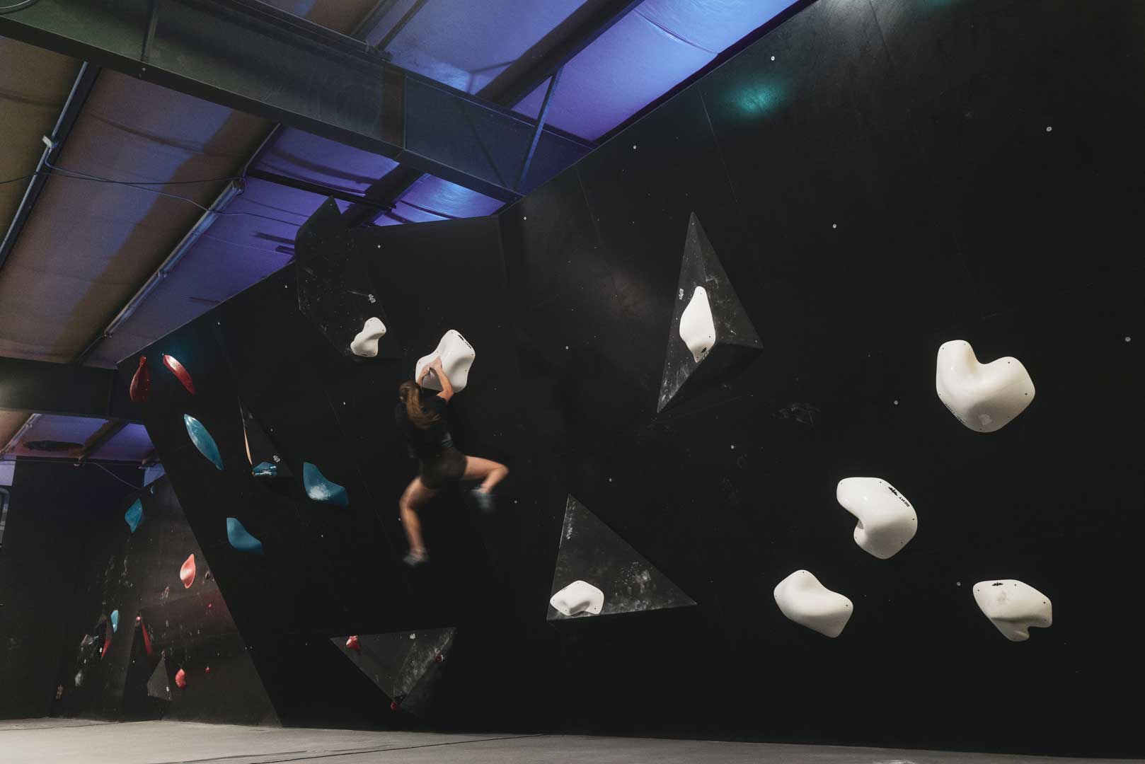 An athlete cuts feet on a bouldering problem at the TTC