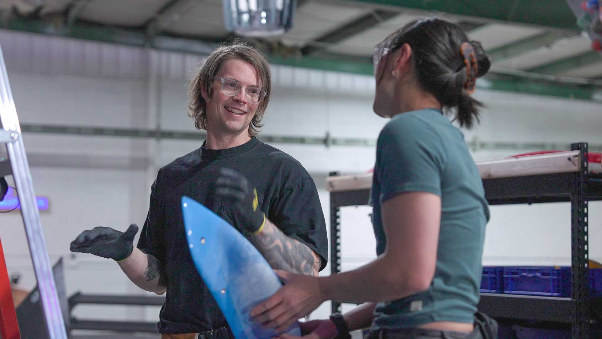 Two routesetters discussing a bouldering problem at the TTC