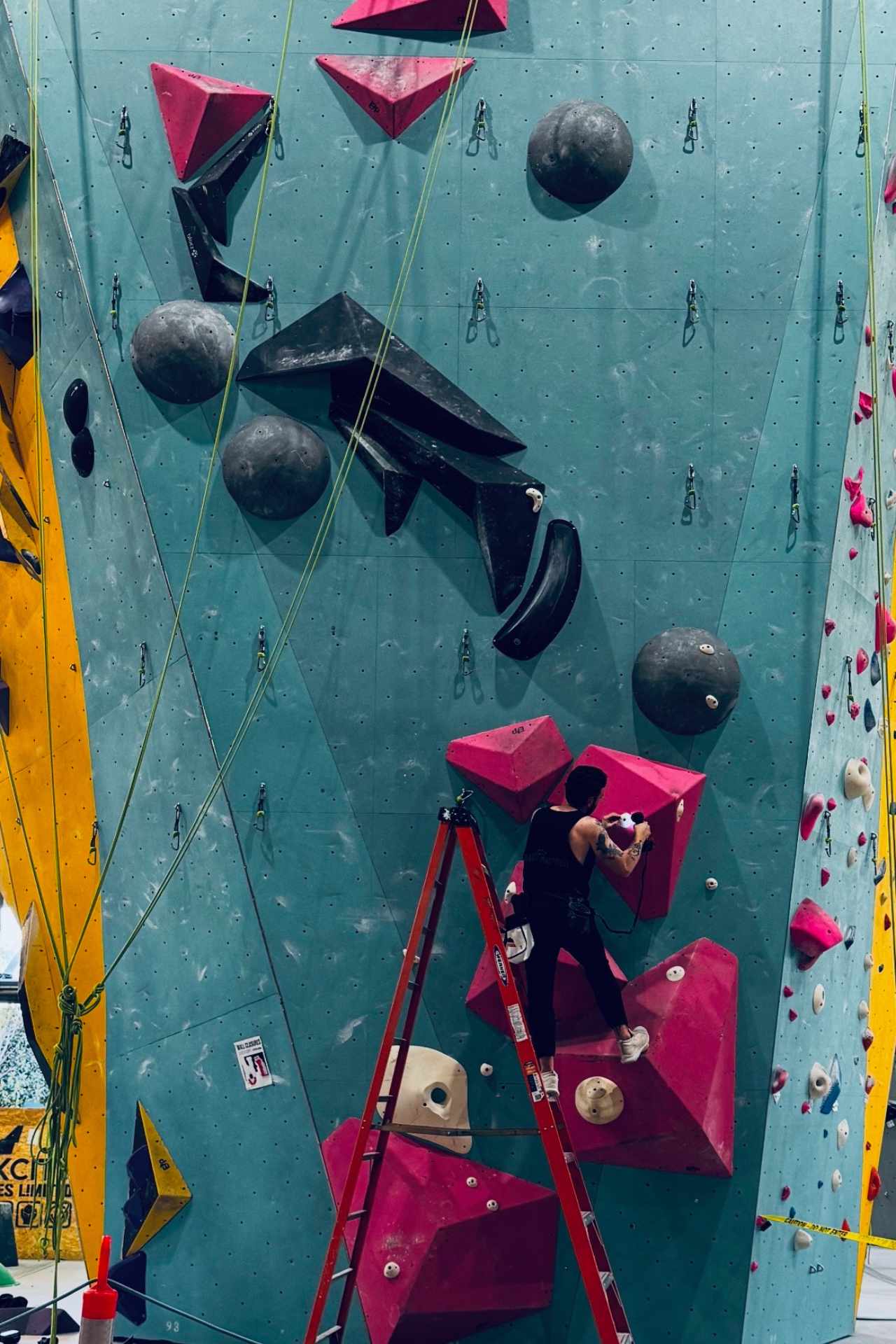 Kenny setting the base of a roped route on a ladder