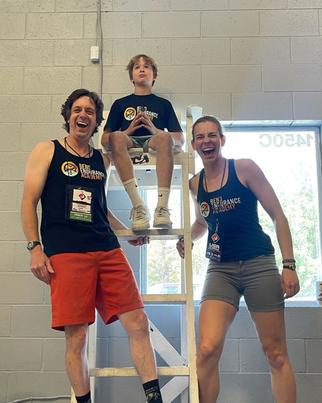 Cate Beebe laughing beside a coach and youth climber