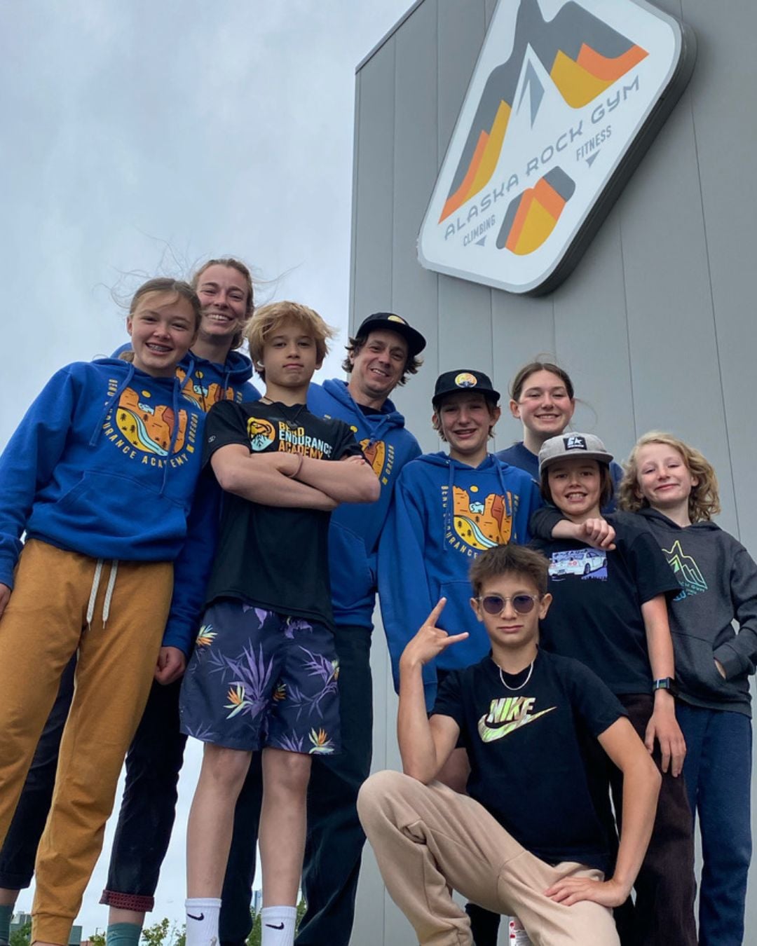 Cate in a team photo outside Alaska Rock Gym