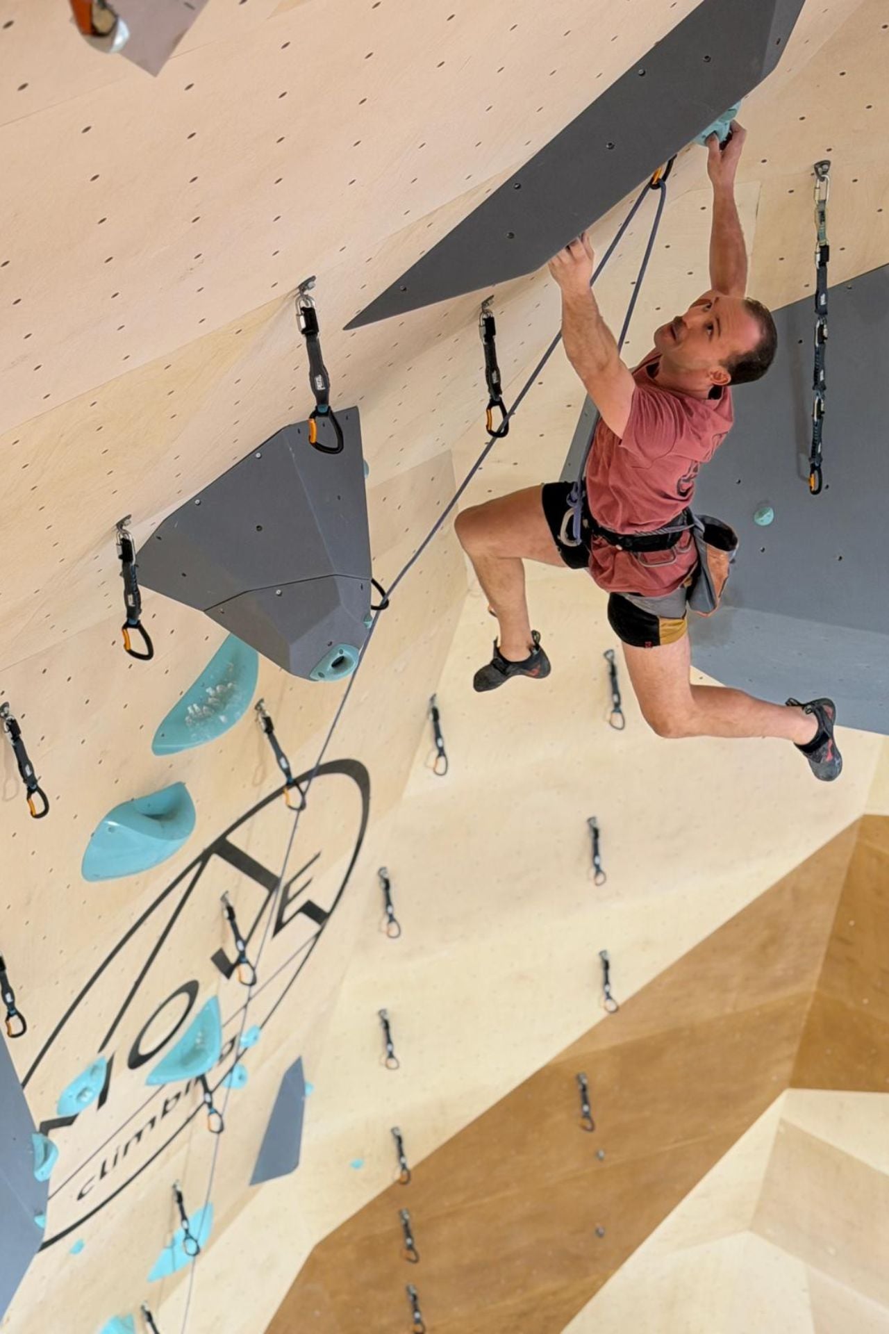 A climber lead climbing at the new gym