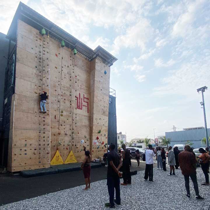 Lagos community members climbing and standing in front of Weland's roped walls