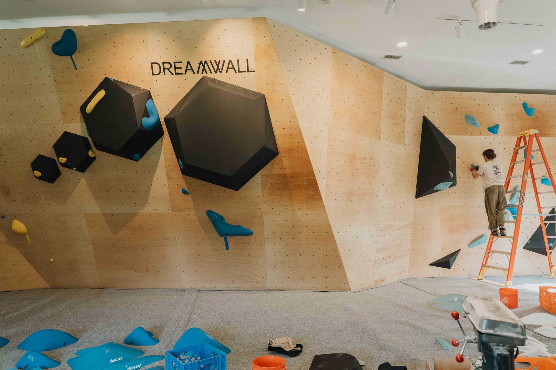 Setting holds on the gym's bouldering walls