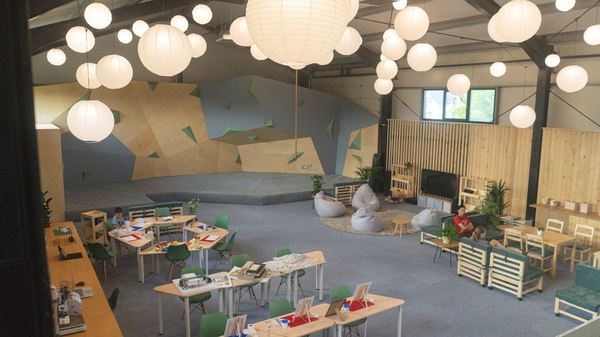 The lounge and work areas next to the climbing wall