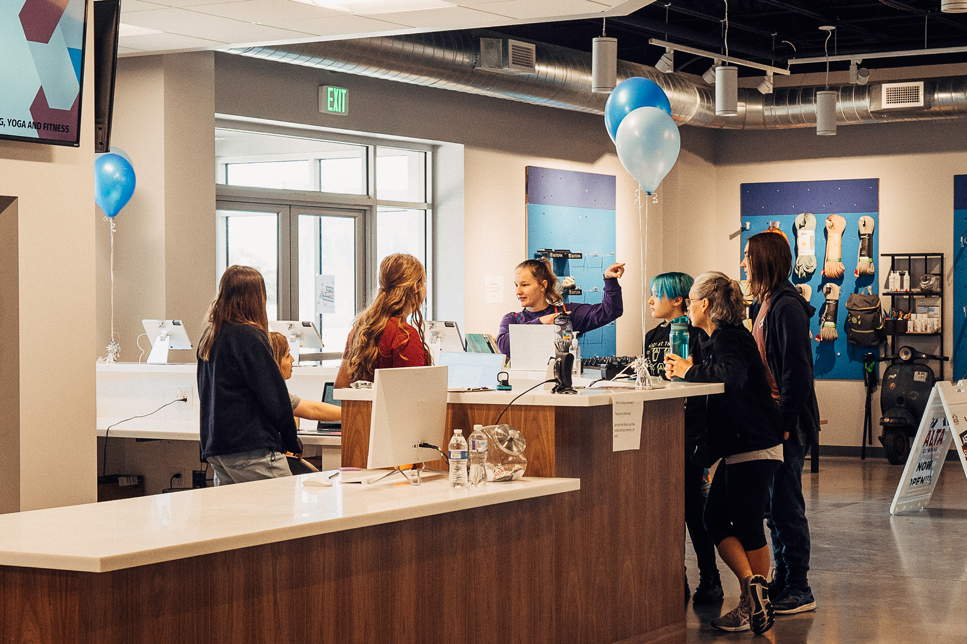 Front desk employees assist a group of climbers at the counter