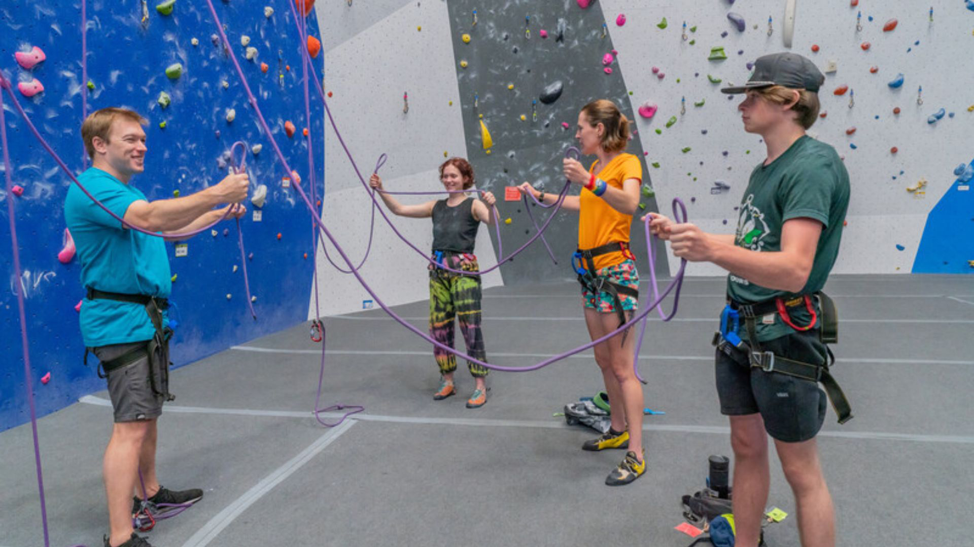 An introductory group instructional class in a climbing gym