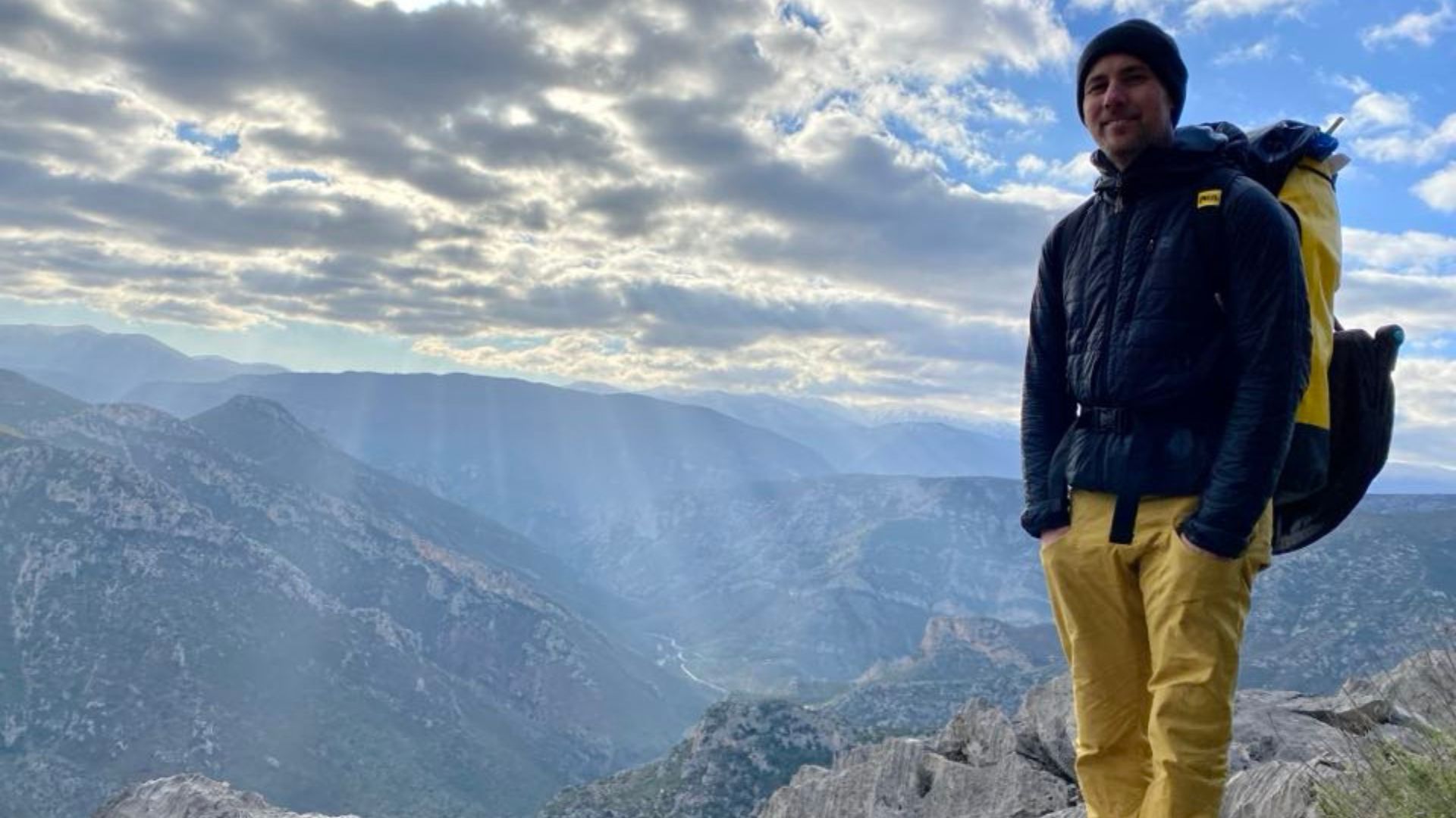 Francis Larose outside, with mountainous terrain in the background