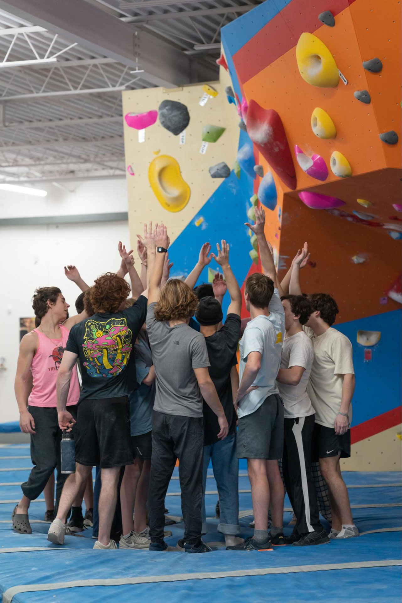 Youth climbers in a team huddle