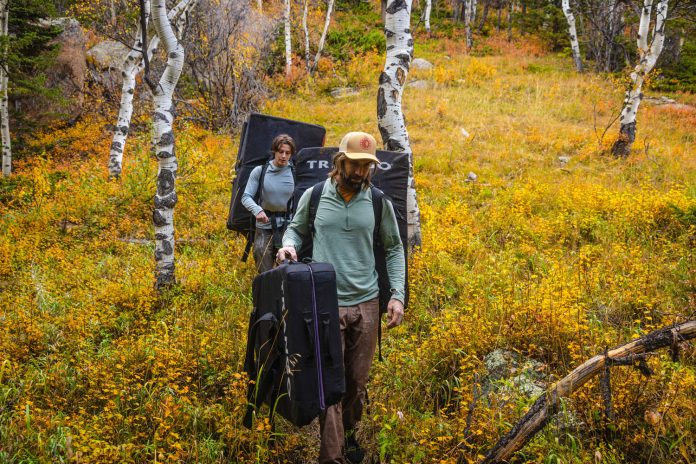 image of two climbers walking with crashpads